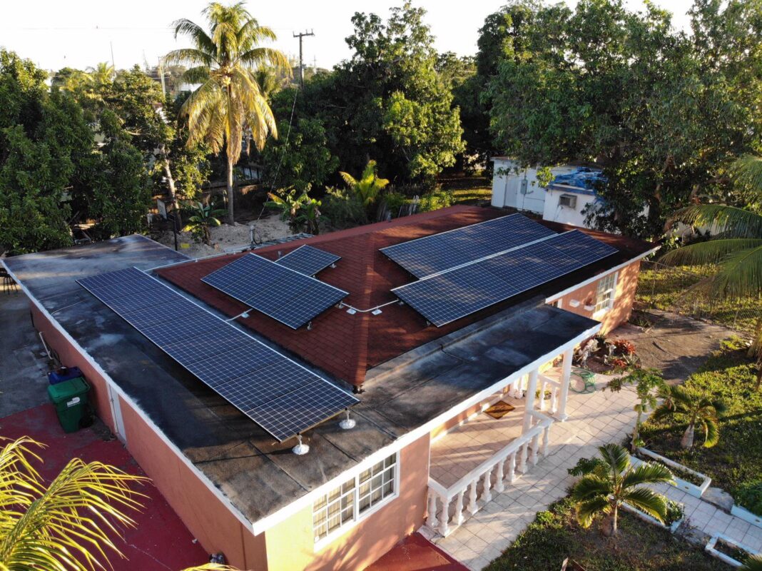 Solar Panels on a roof in Florida, done by Solar Construction LLC. It's nearing dusk and a warm light blankets the area.
